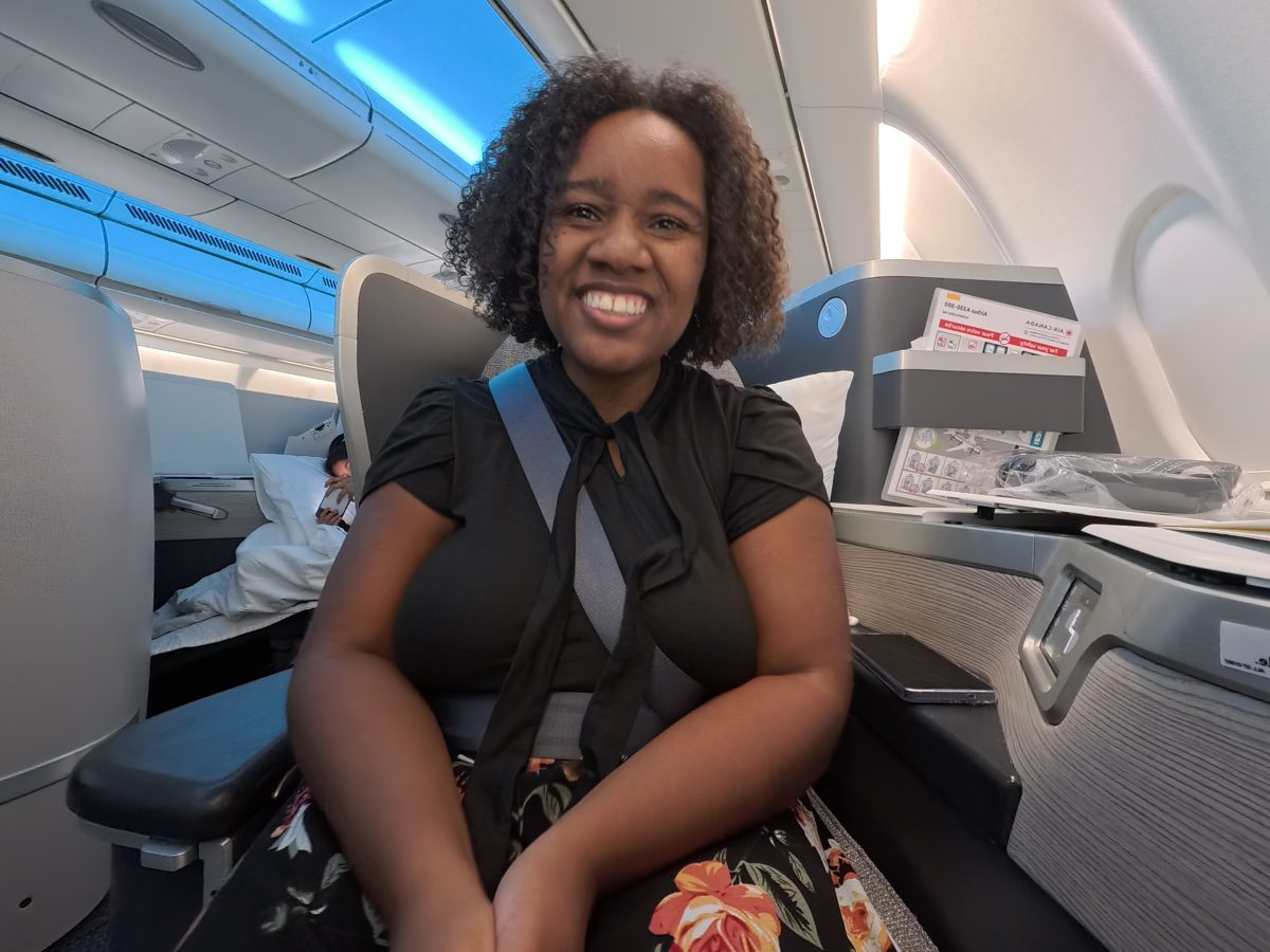 Deja seated in her Air Canada business class seat, the flight she had to fight for