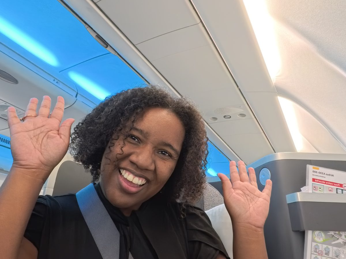 Deja waving from her Air Canada seat