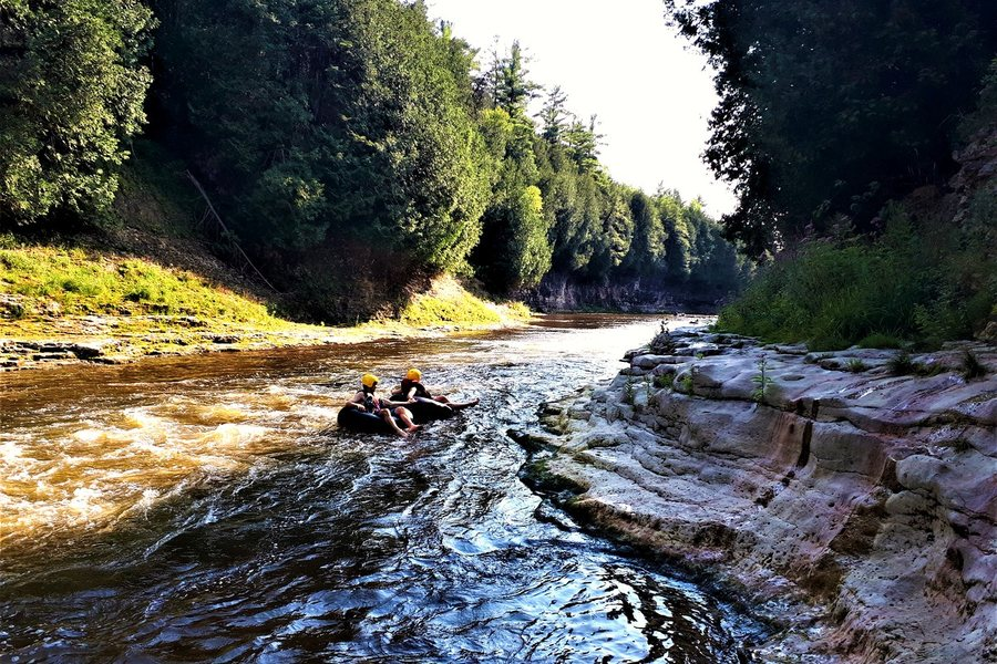 Two people tubing down the river through the Elora Gorge